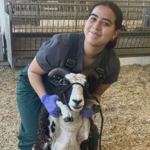 Nicole Forero, vet assistant, with a goat