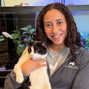 Bibi Rios, vet assistant, holding little black and white cat